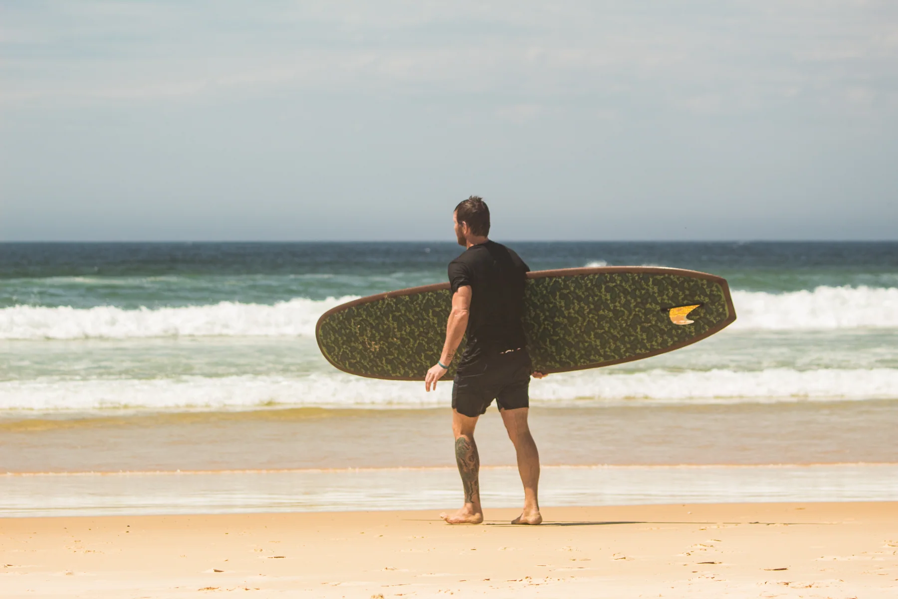 Client carrying a botanical-art Yugen longboard