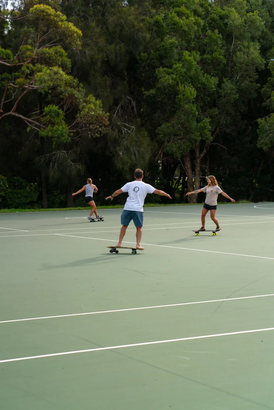 Group surf-skate session on an outdoor court